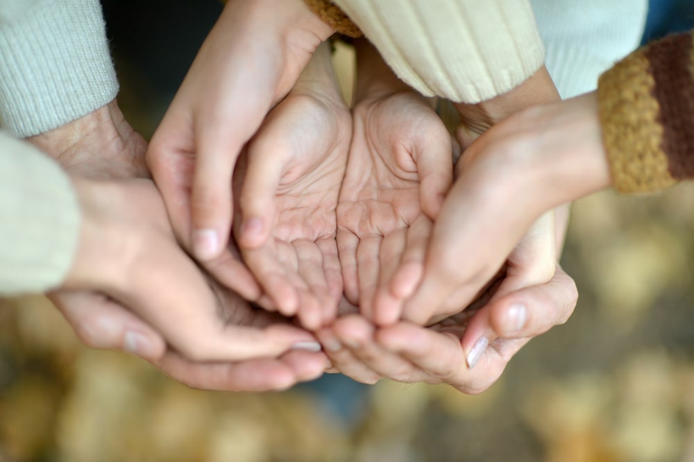 Multiple people Holding Hands Together